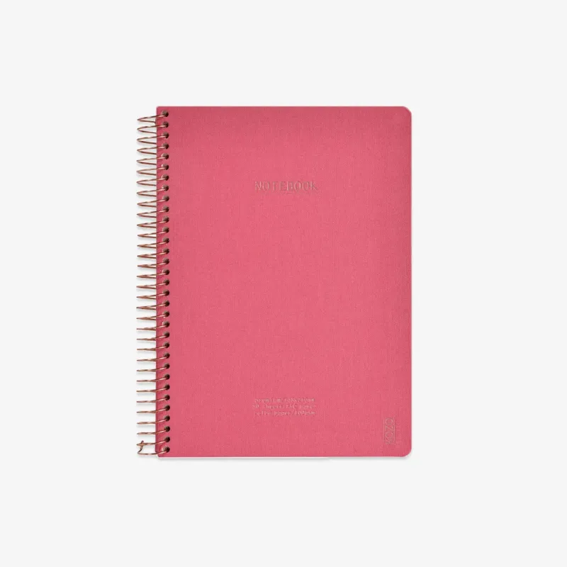 Pink notebook with spiral binding on a white background